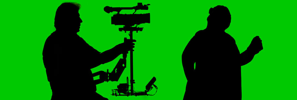 Image of camera and actor silhouette against chroma screen